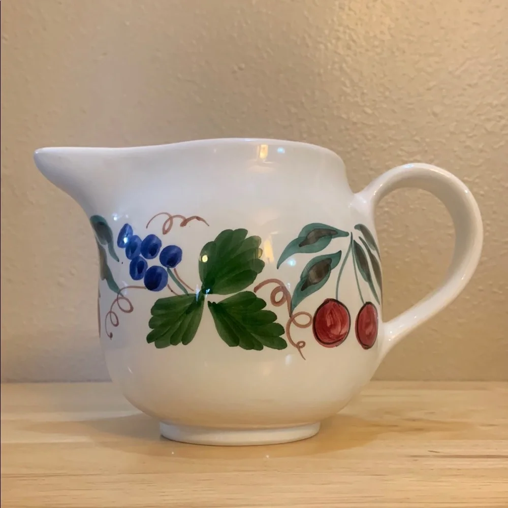 Crate & Barrel white ceramic pitcher hand painted with cherries and grapes.